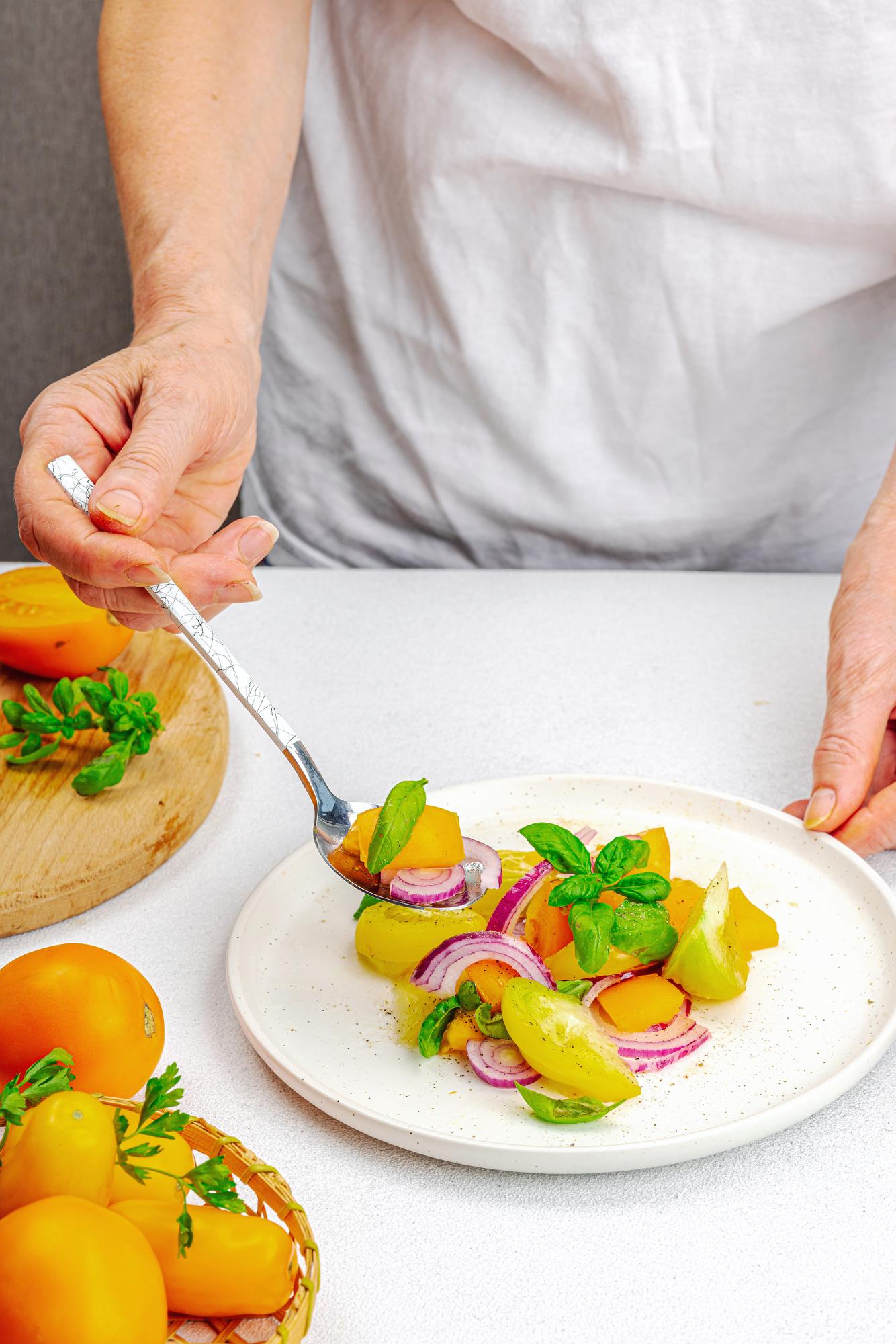 chef arranging plated meal in studio kitchen